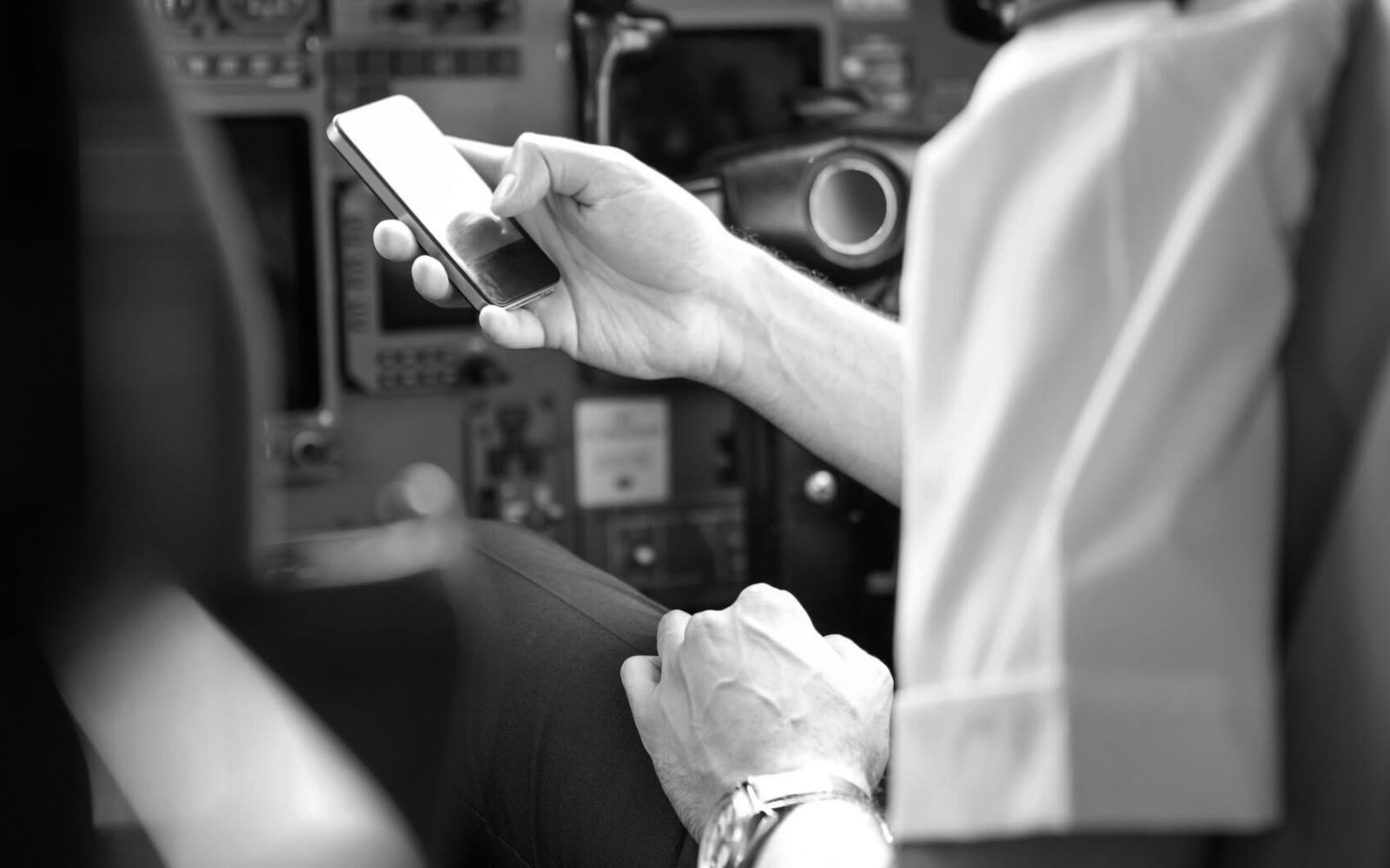 Pilot using a phone in the flight deck